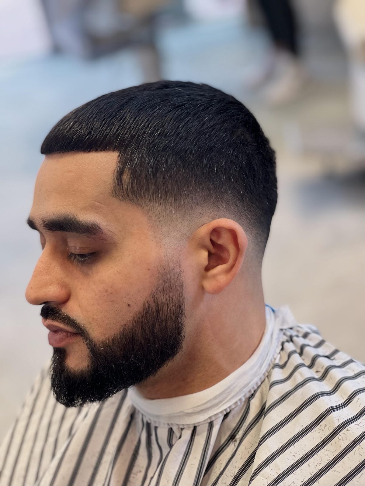 Skin fade blended into a full beard